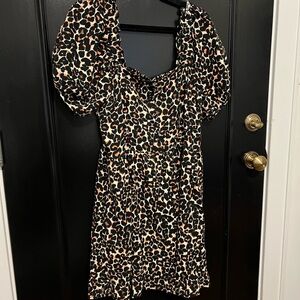 Leopard print dress with orange accents and button details.